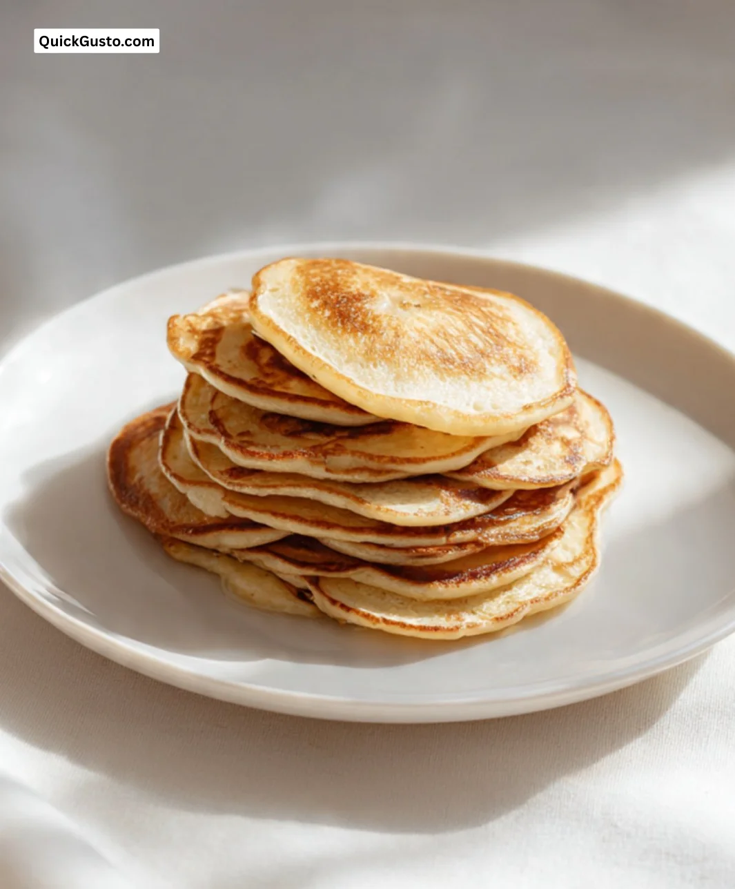 Fluffy 2-ingredient banana pancakes served with syrup and fresh fruit