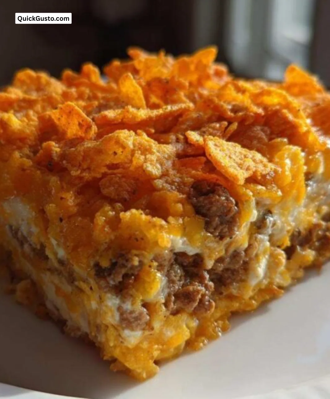 Delicious Dorito Casserole in a baking dish topped with cheese and Dorito chips
