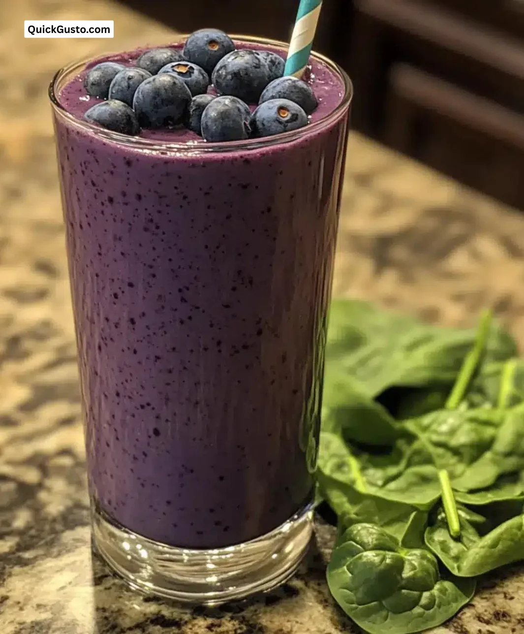 Delicious blueberry spinach smoothie in a glass with fresh ingredients