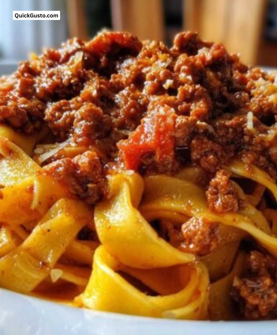 Homemade Bolognese sauce simmering in a pot with fresh ingredients.