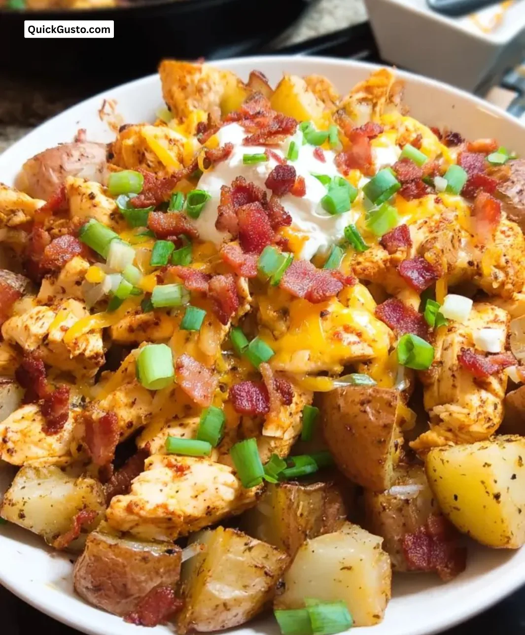 Cajun Chicken Loaded Potato Bake topped with herbs and spices