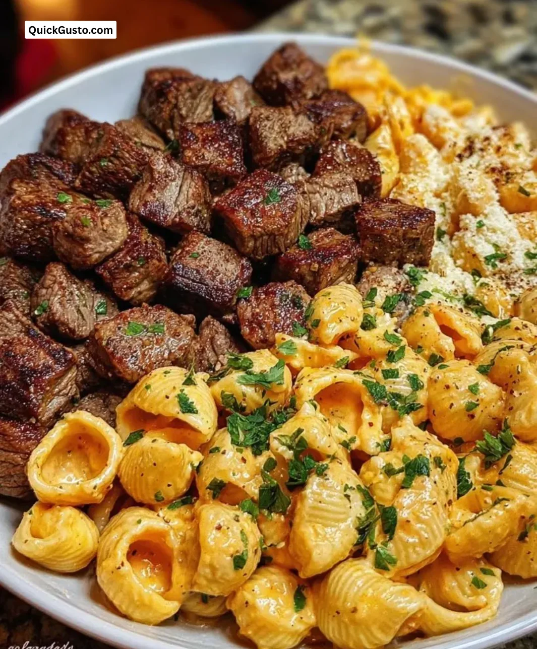 Cajun Steak Bites with Cheesy Garlic Shells in a skillet dish