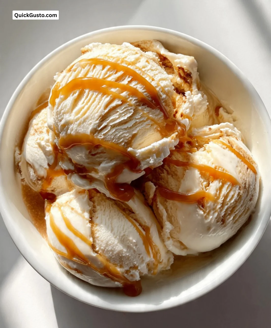 Rich and creamy Caramel Macchiato Ice Cream in a bowl with caramel drizzle
