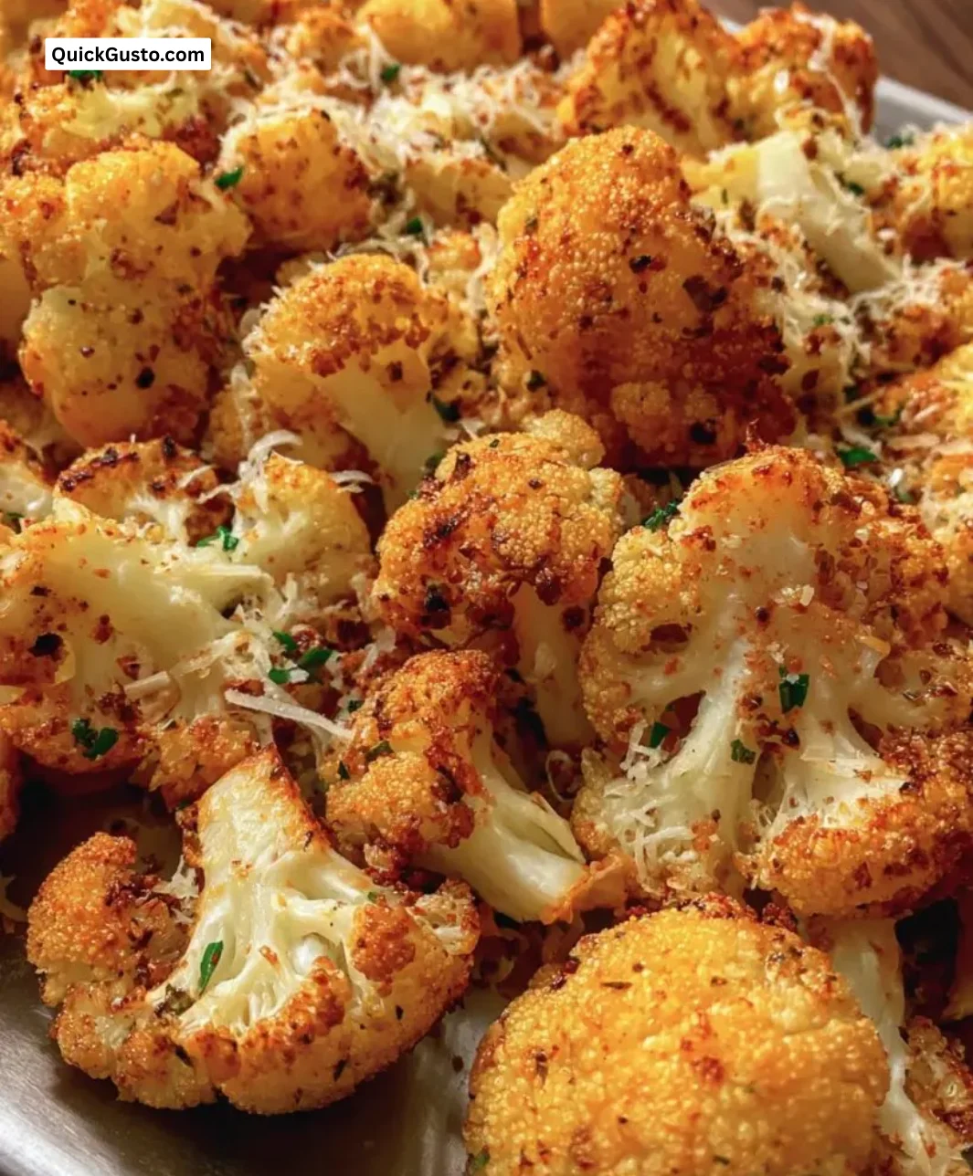 Crispy roasted cauliflower cheddar served on a plate with garnish