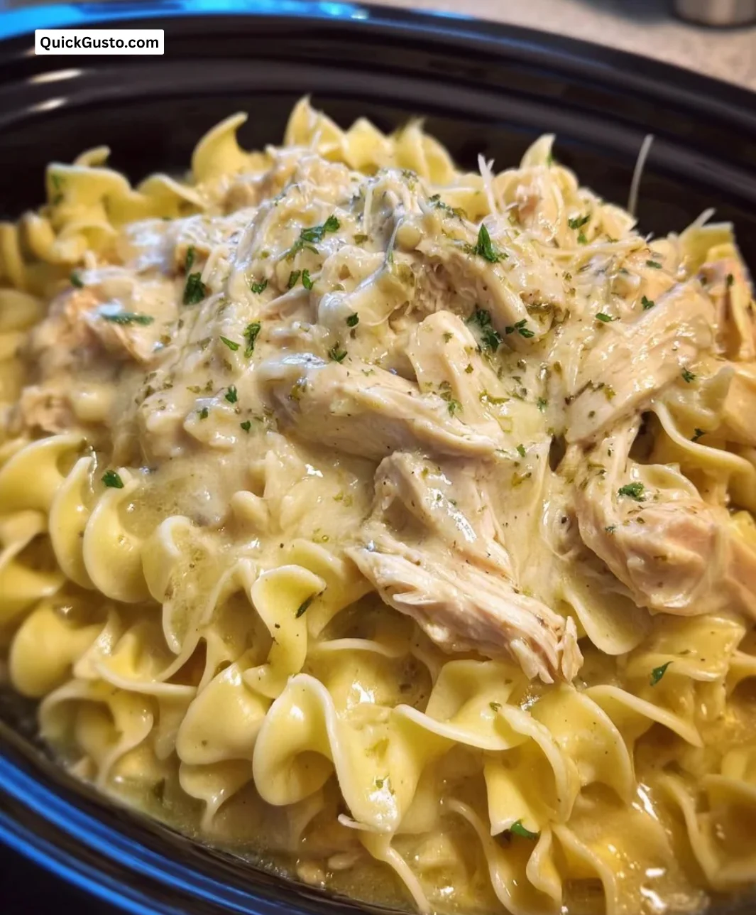 Delicious bowl of Crockpot Chicken and Noodles topped with herbs