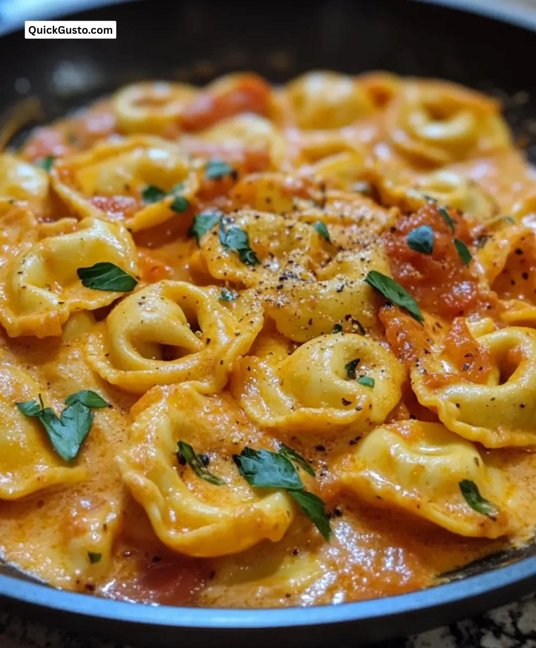 Creamy tomato tortellini skillet dish with fresh basil and cheese