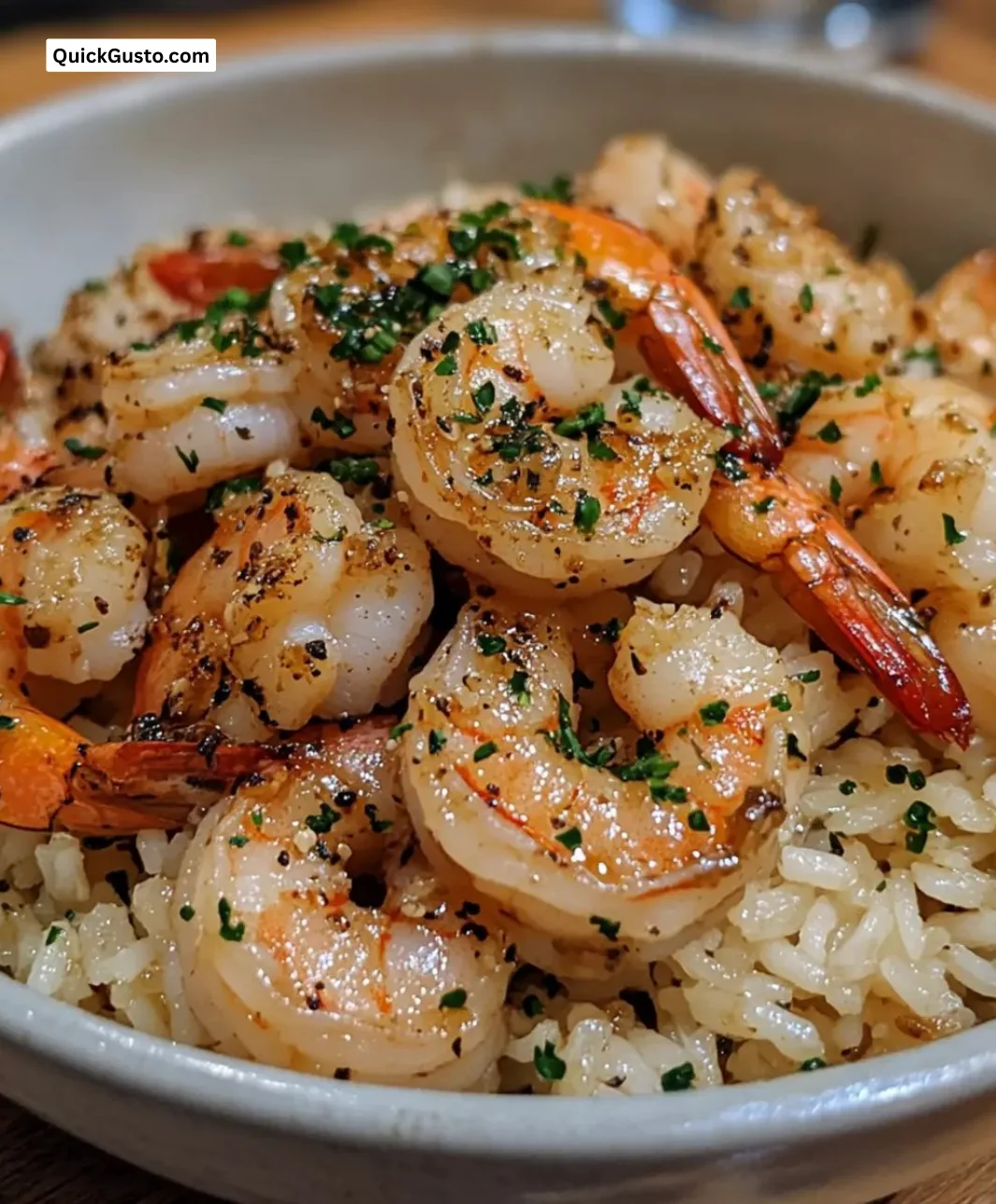 Plate of easy garlic butter shrimp rice garnished with herbs