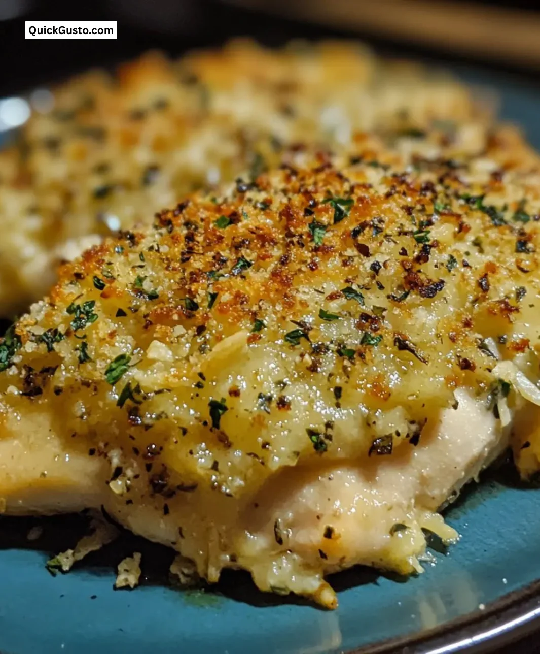 Delicious easy Parmesan crusted baked chicken served with herbs and spices