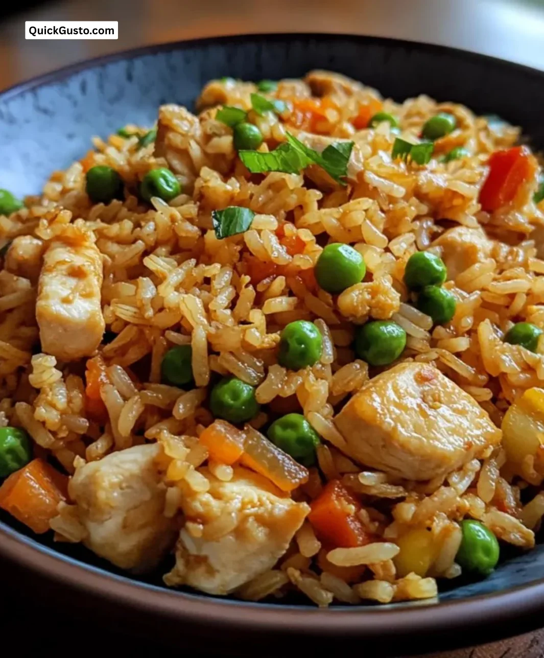 Delicious easy chicken fried rice served in a bowl with vegetables and chicken.
