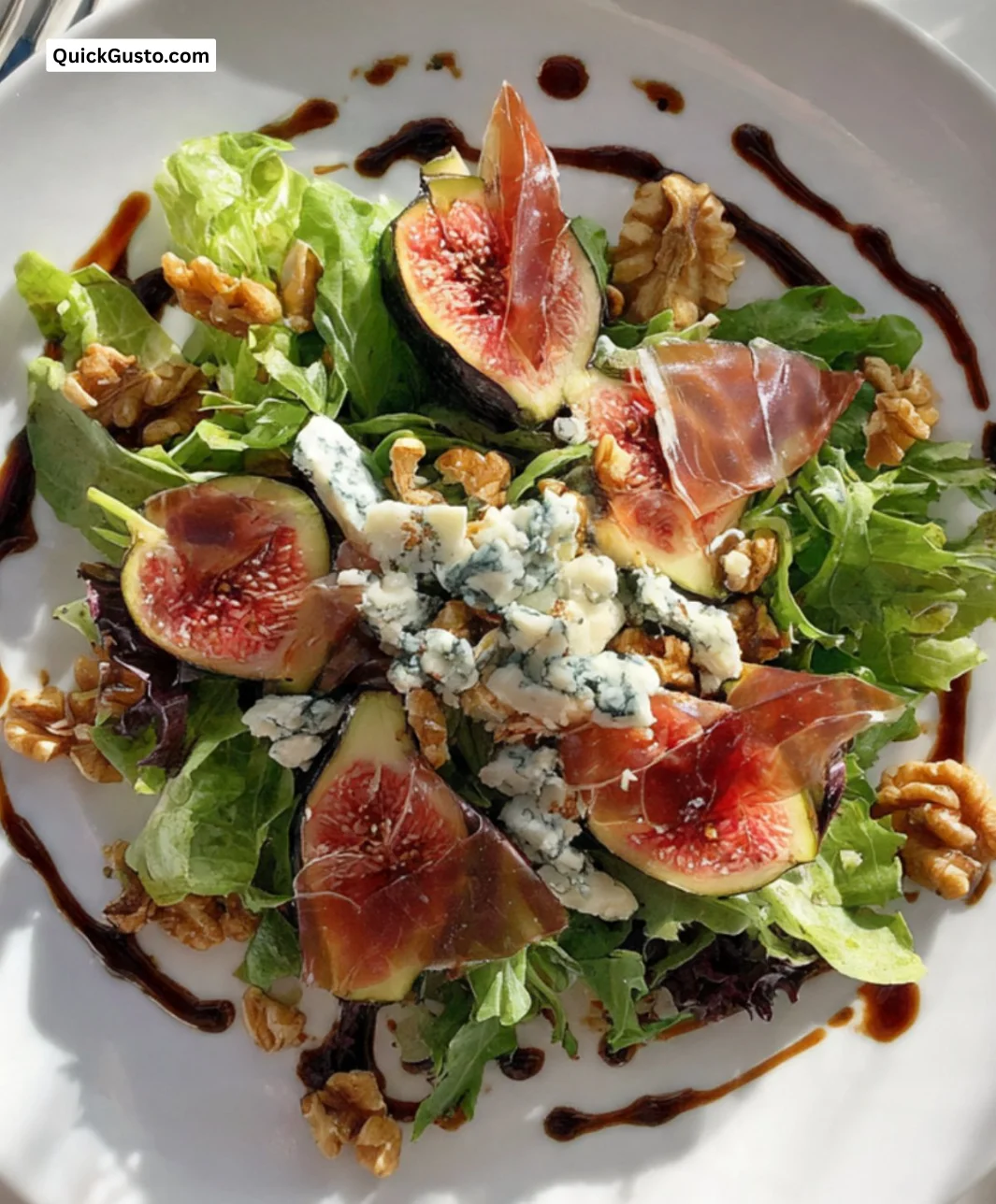 Fig Salad with Blue Cheese and Crispy Prosciutto garnished with fresh herbs