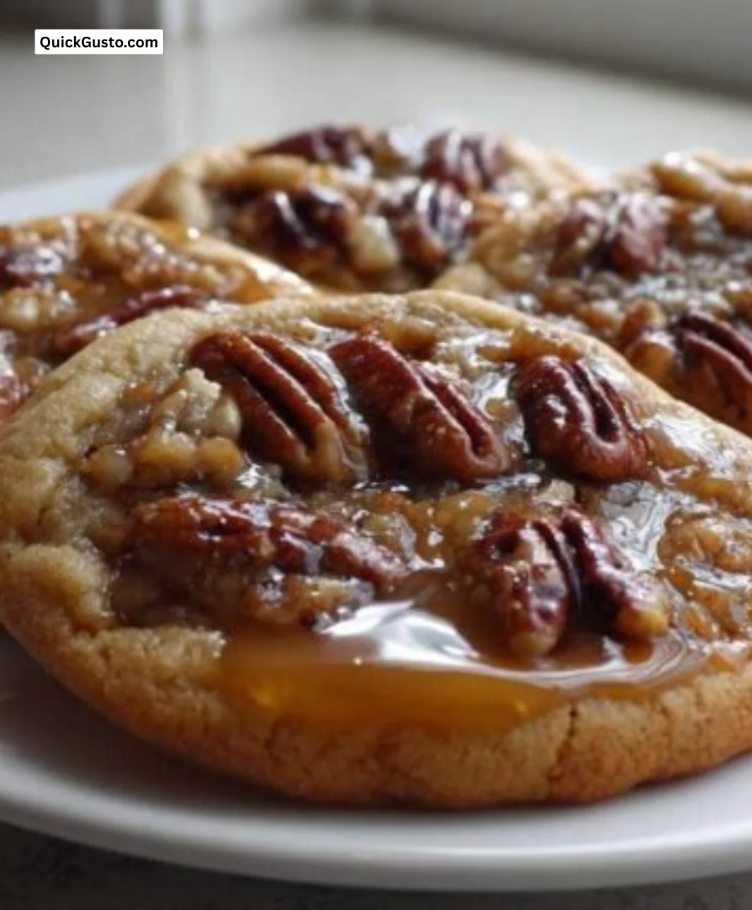 Delicious pecan pie cookies topped with pecans and drizzled with caramel