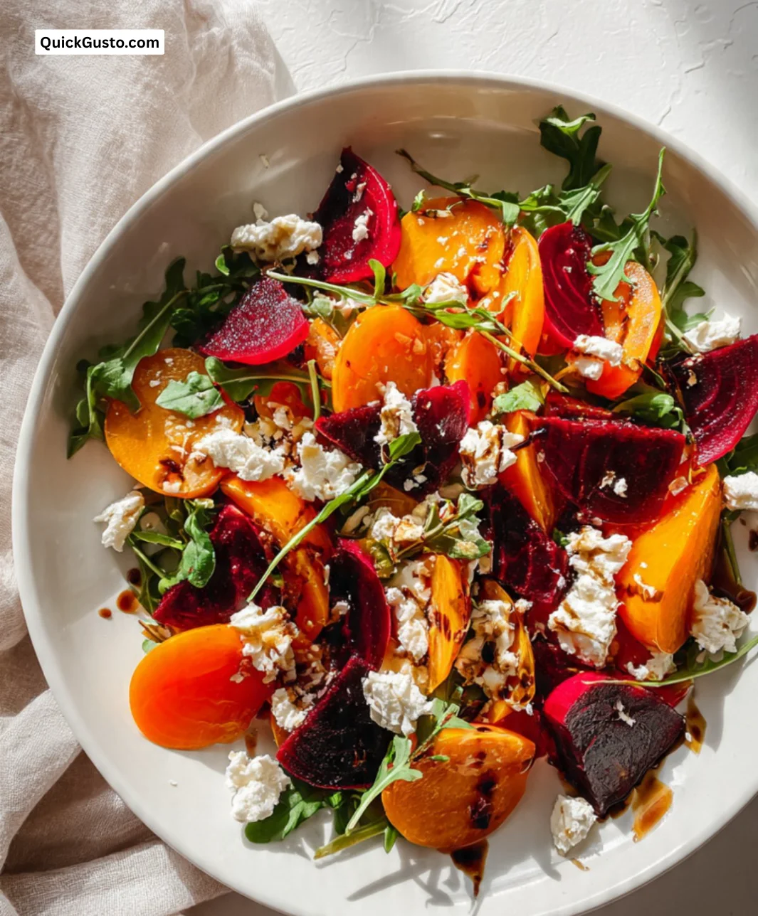 Vibrant persimmon beet salad with fresh greens and nuts.