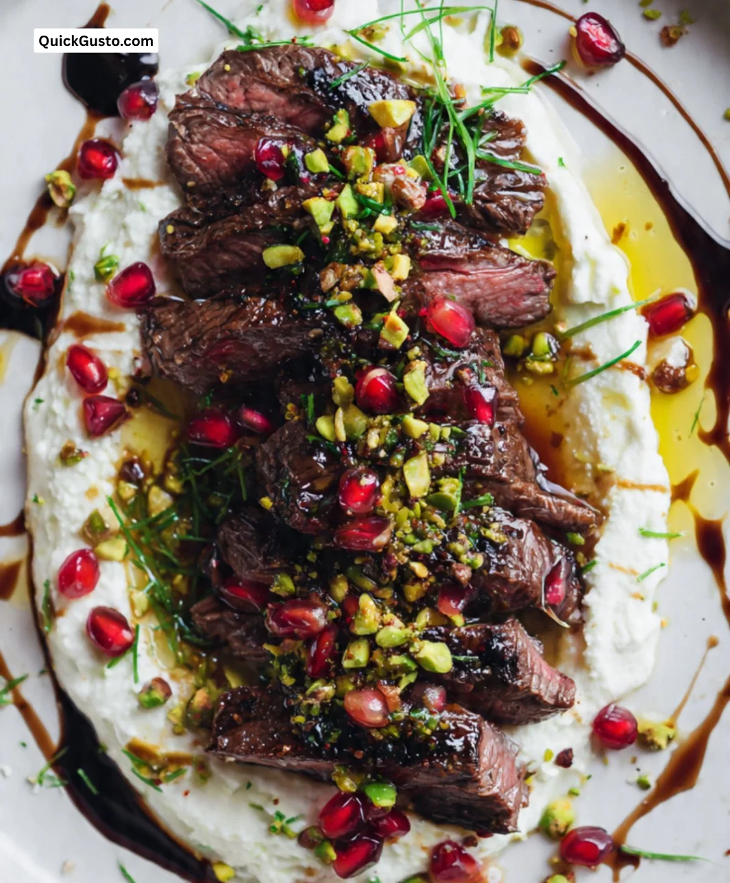 Pomegranate skirt steak served with whipped feta on a plate