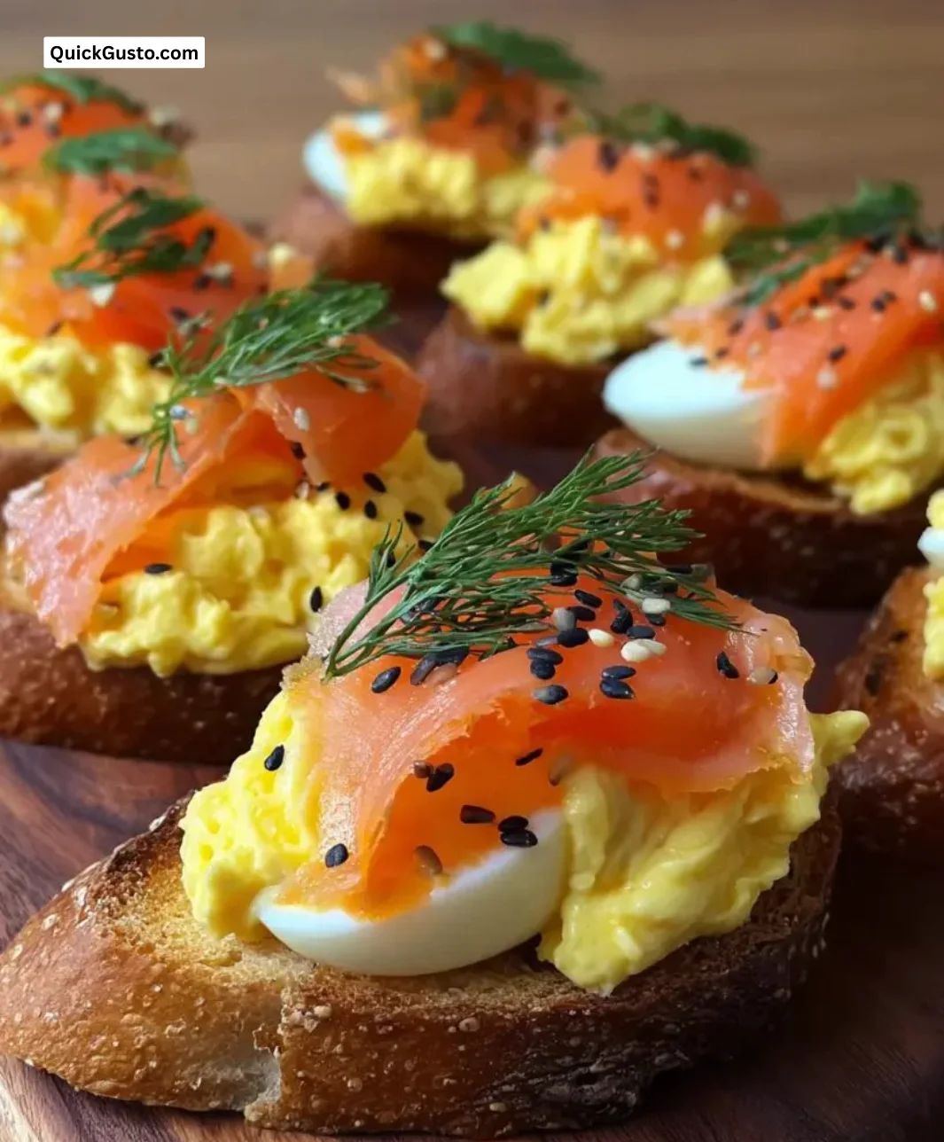 Smoked salmon crostini topped with egg mousse on a serving platter