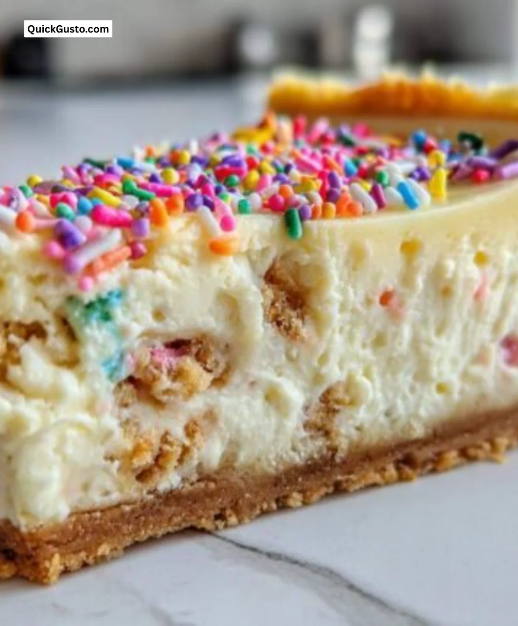 Delicious sugar cookie cheesecake topped with colorful sprinkles and cream.
