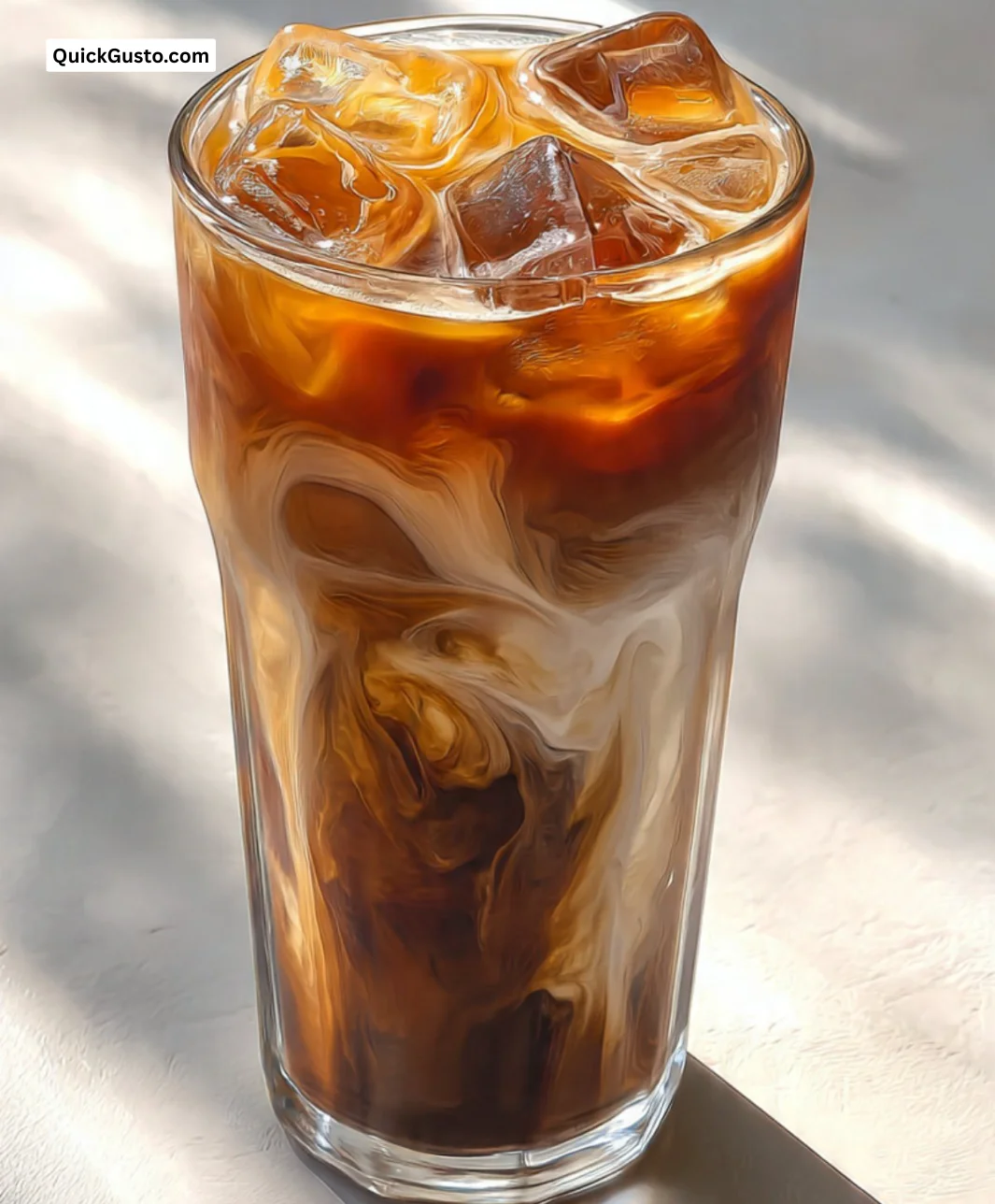 Delicious Tipsy Iced Coffee served in a glass with ice and a creamy topping