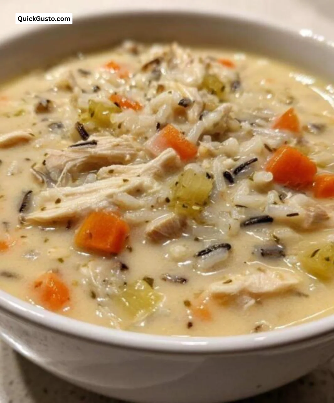 A steaming bowl of delicious wild rice soup with fresh ingredients