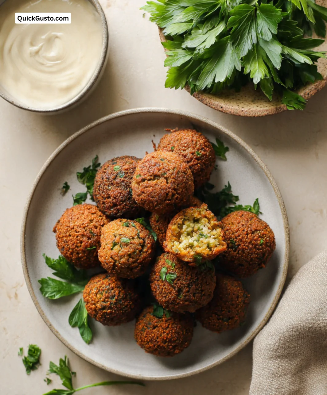 Plate of authentic Middle Eastern falafel served with tahini sauce and fresh vegetables