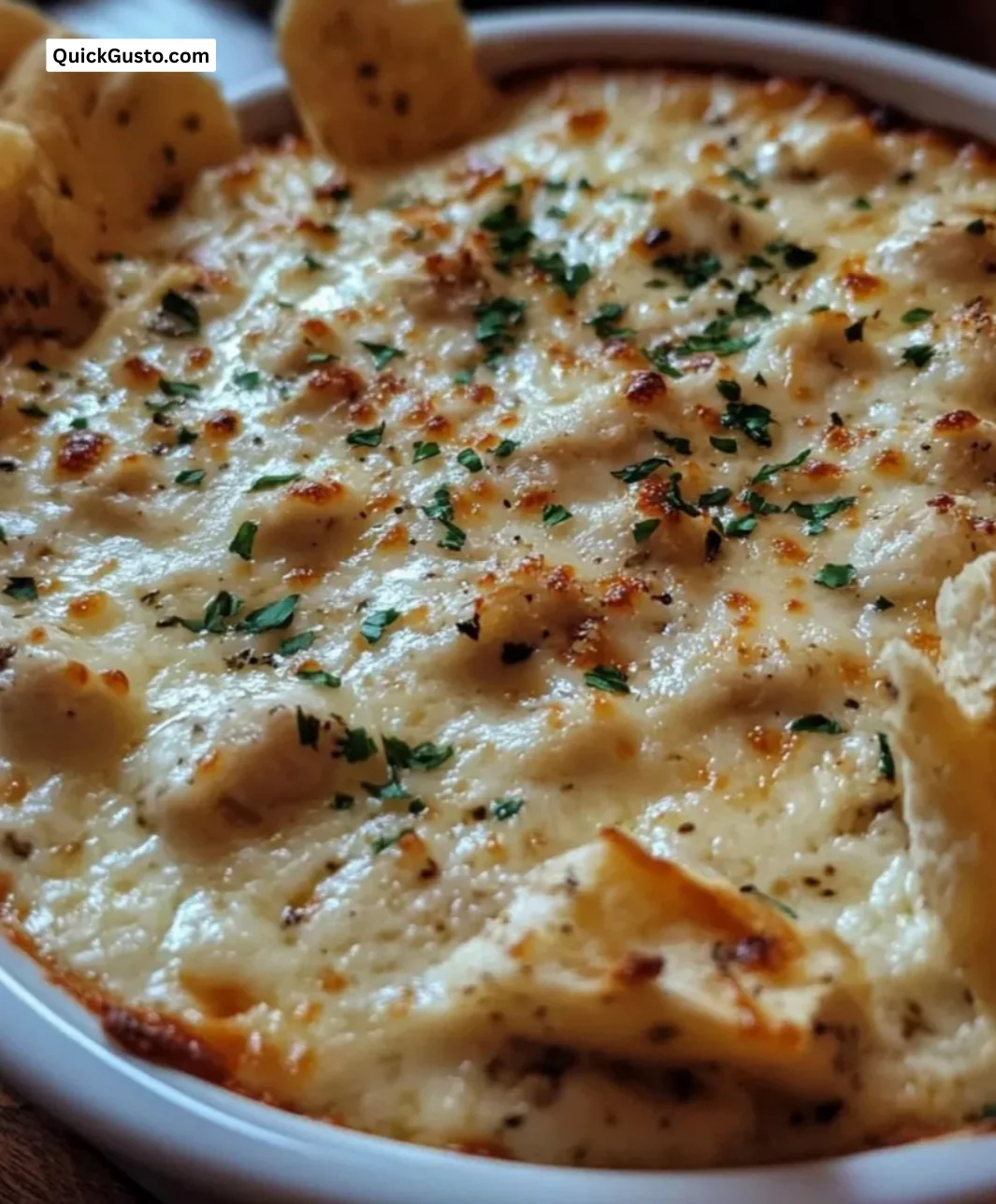 Creamy garlic parmesan chicken dip served in a bowl with tortilla chips