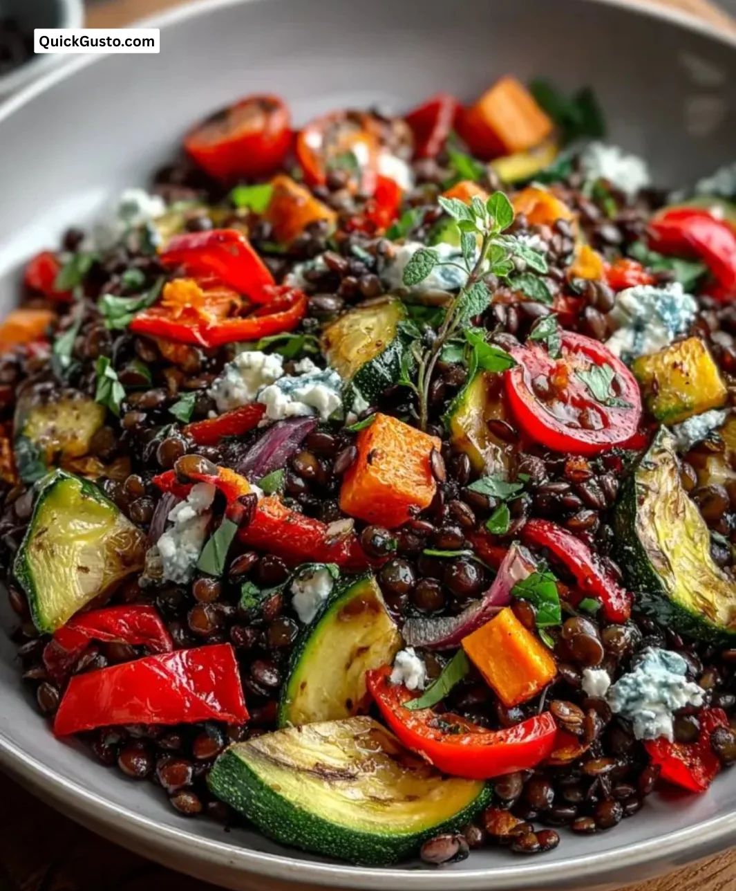 Black lentil salad topped with roasted vegetables for a nutritious meal