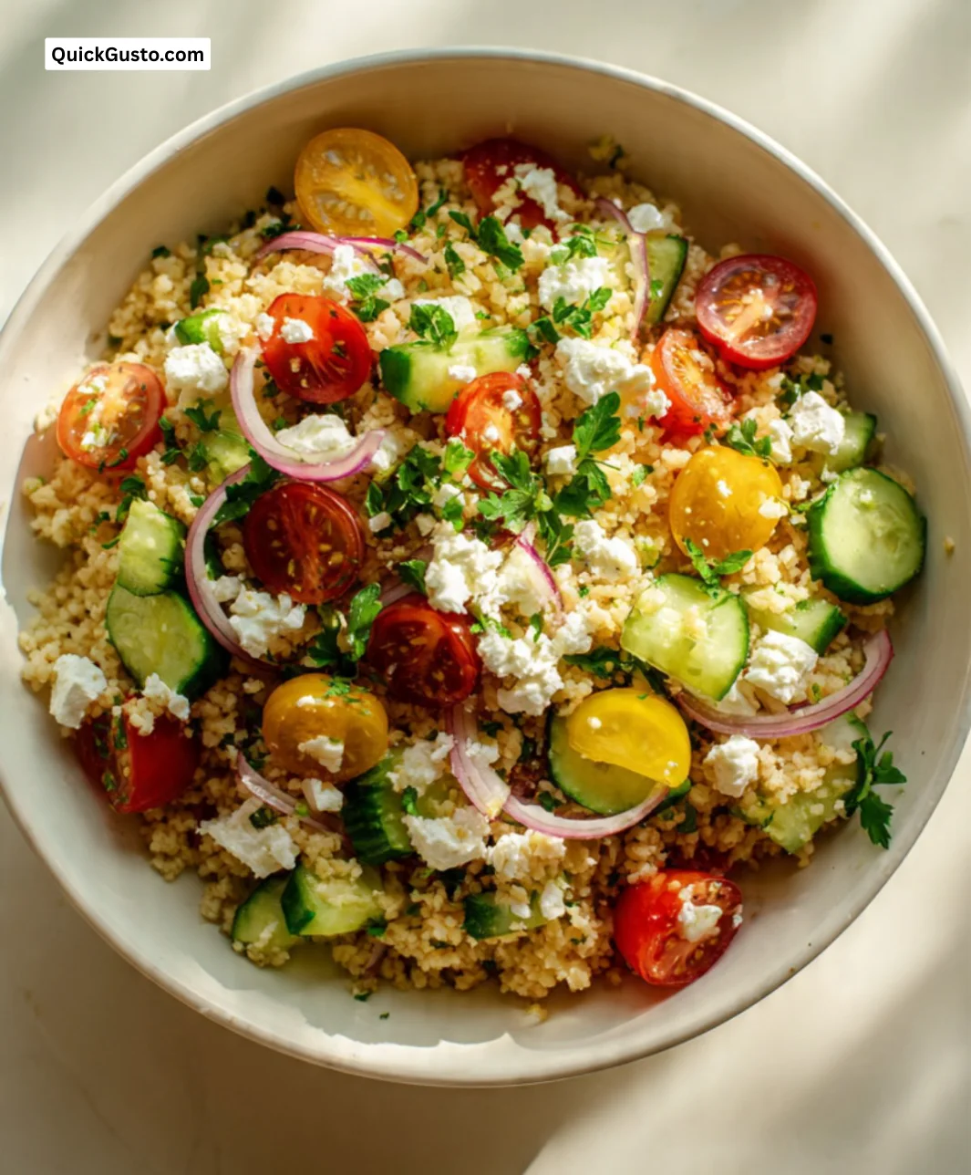 Bulgur salad topped with Greek style cheese and fresh vegetables