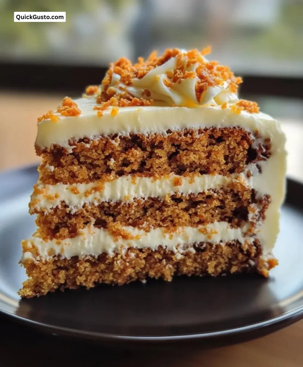 Moist classic carrot cake with cream cheese frosting and walnuts on a plate.