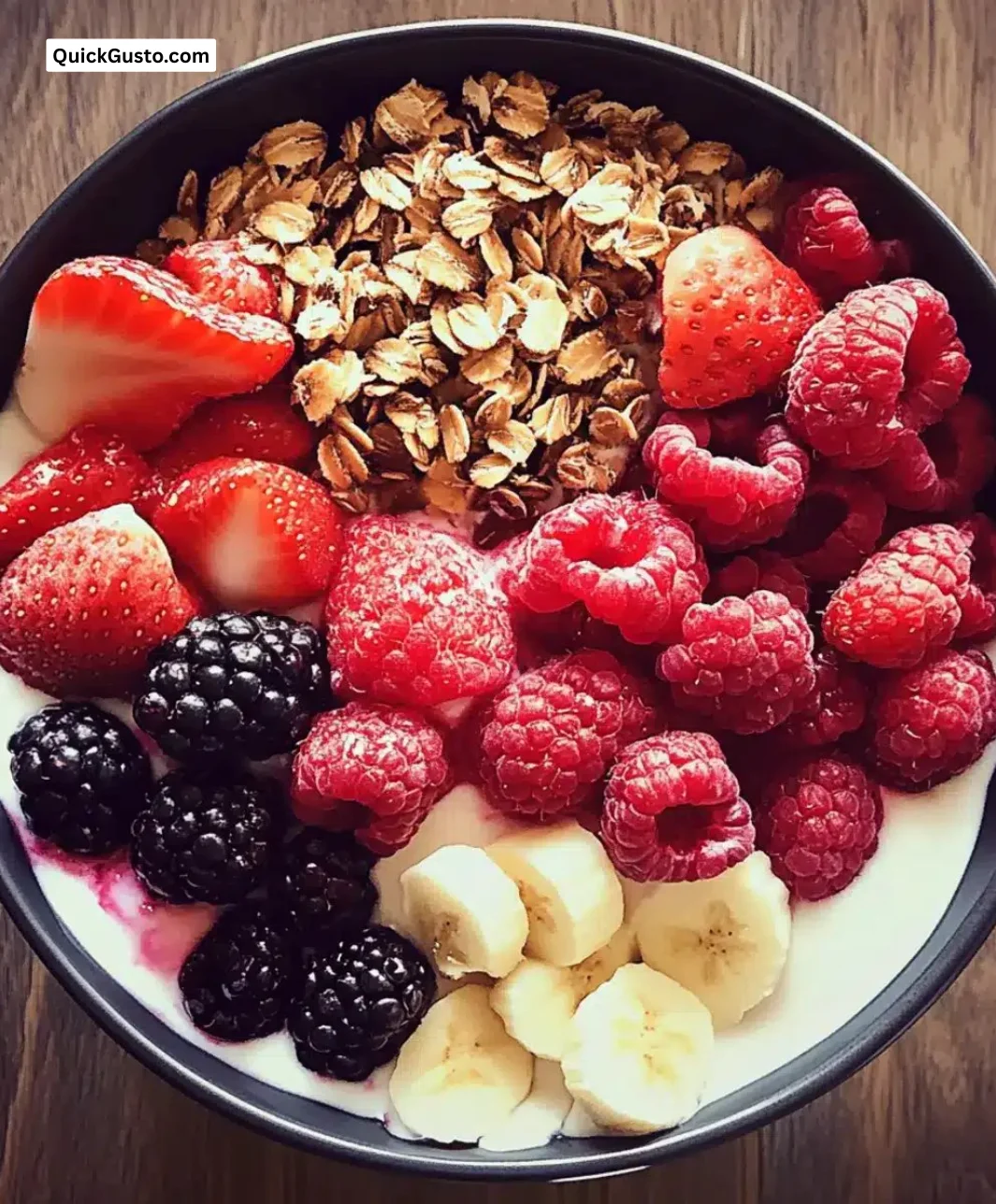 Easy berry yogurt breakfast bowl topped with fresh berries and granola.