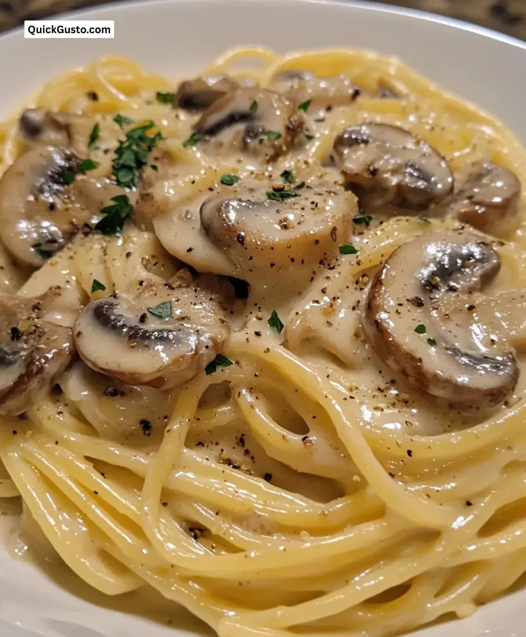 Delicious creamy garlic mushroom pasta in a bowl garnished with parsley