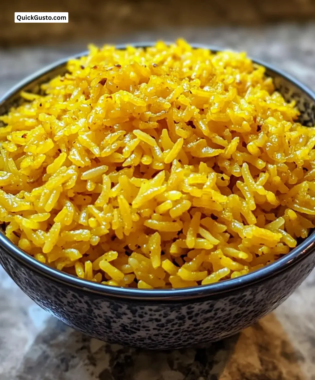 A bowl of easy Instant Pot coconut turmeric rice garnished with herbs