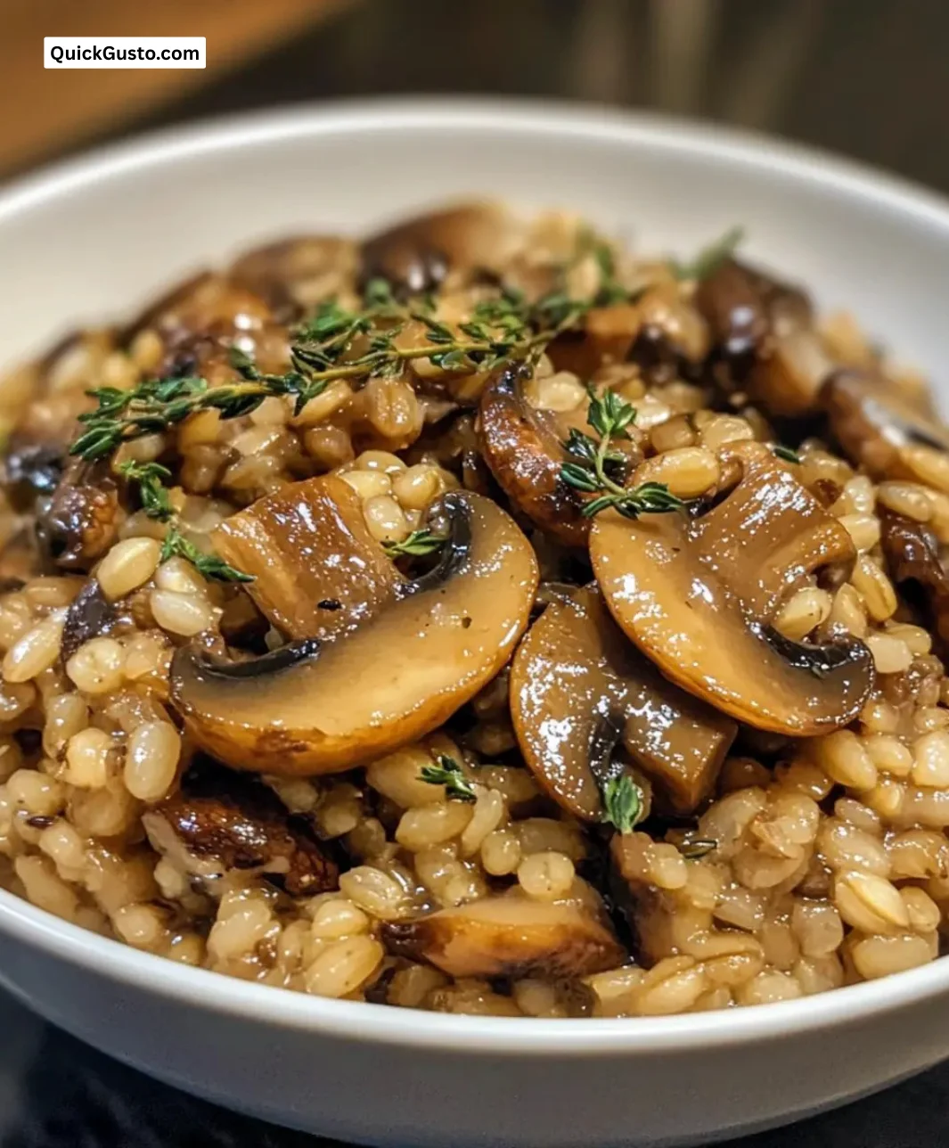 Delicious mushroom barley pilaf with thyme served in a bowl.