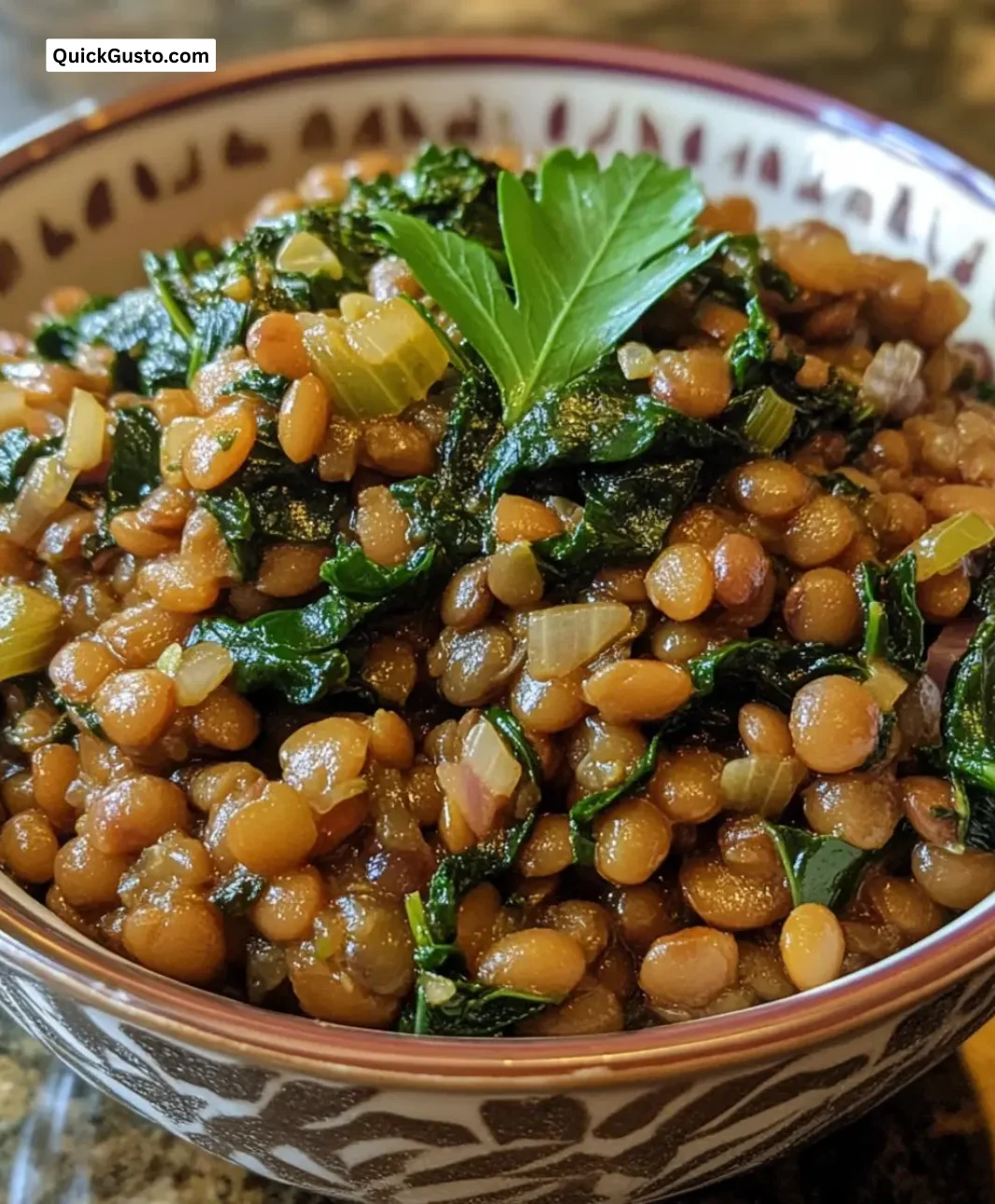 Bowl of easy slow cooker Lebanese lentils with Swiss chard and spices.