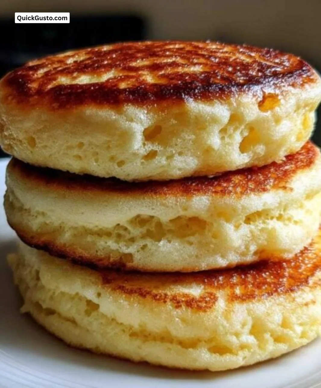 Delicious fluffy pancakes stacked on a plate with syrup and berries