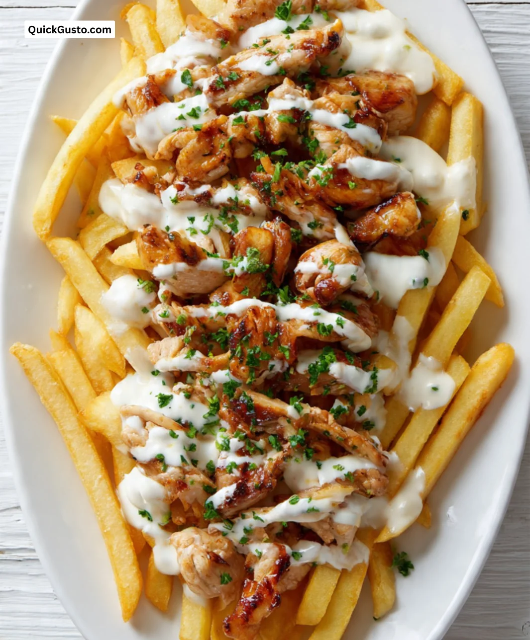 Plate of French fries served with grilled chicken kebab.