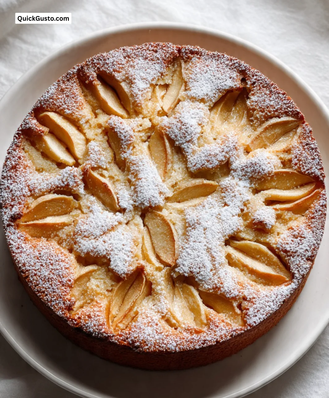 Delicious German Apple Cake with golden apples and cinnamon topping.
