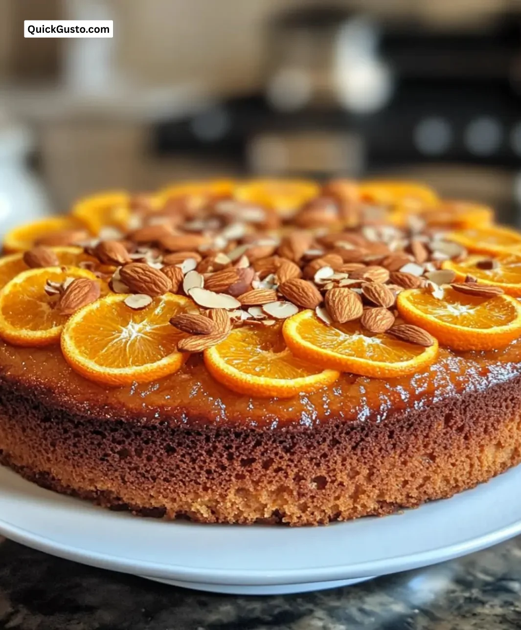 Gluten-free orange almond cake drizzled with olive oil, garnished with orange zest.