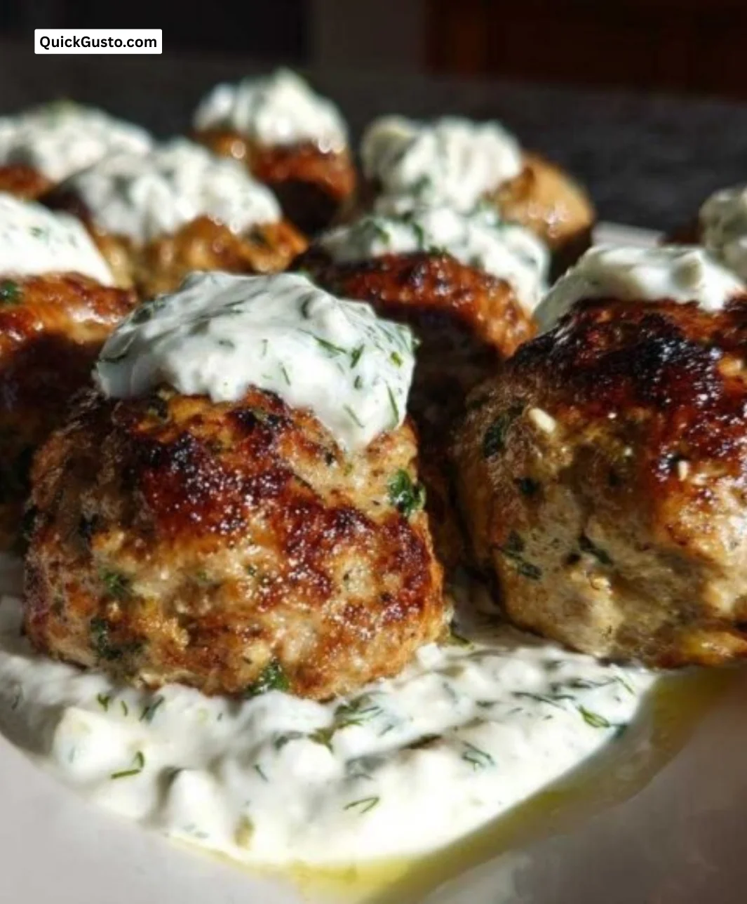 Delicious Greek chicken meatballs served with tzatziki and herbs