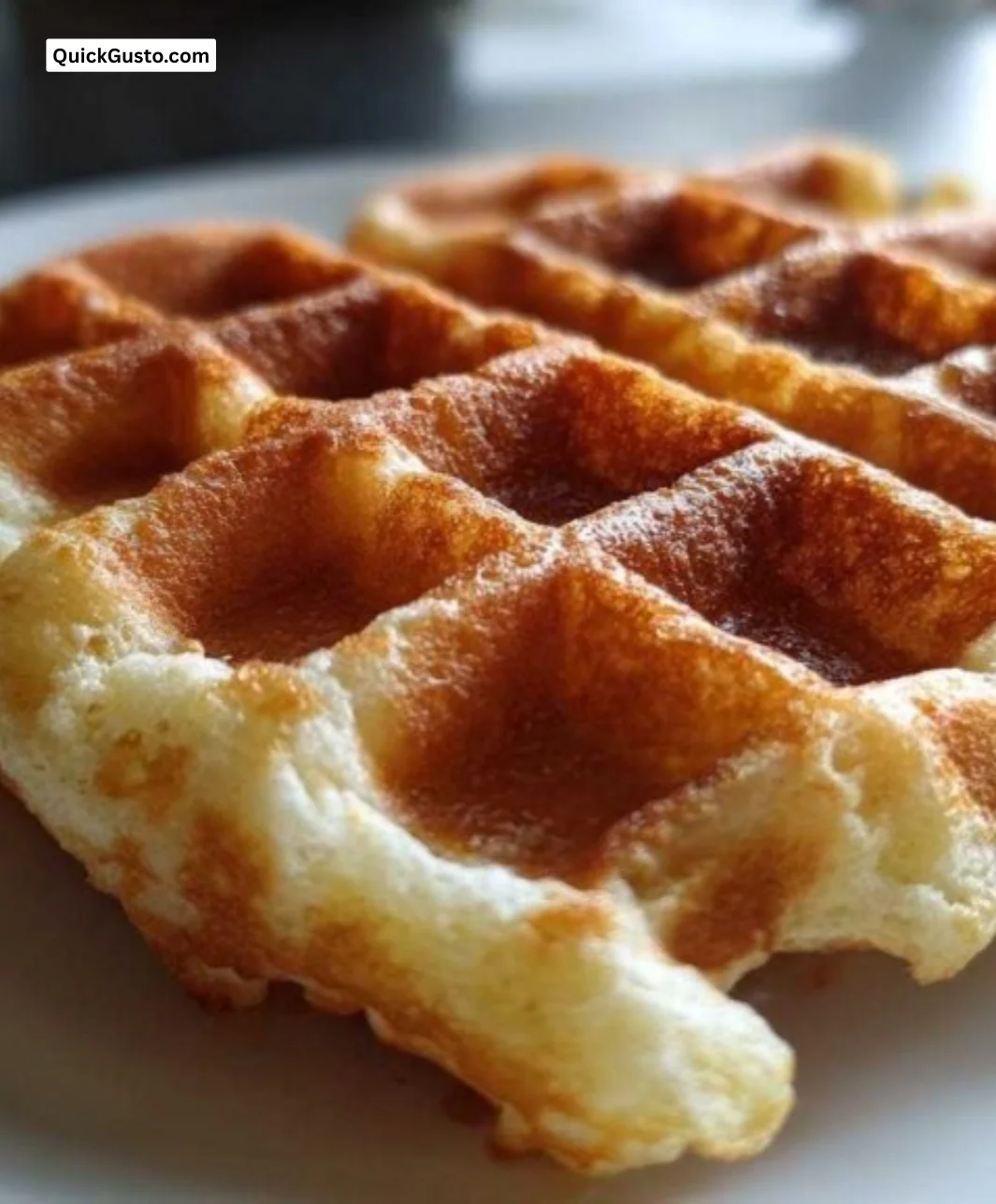 High protein waffles stacked on a plate, topped with fresh berries