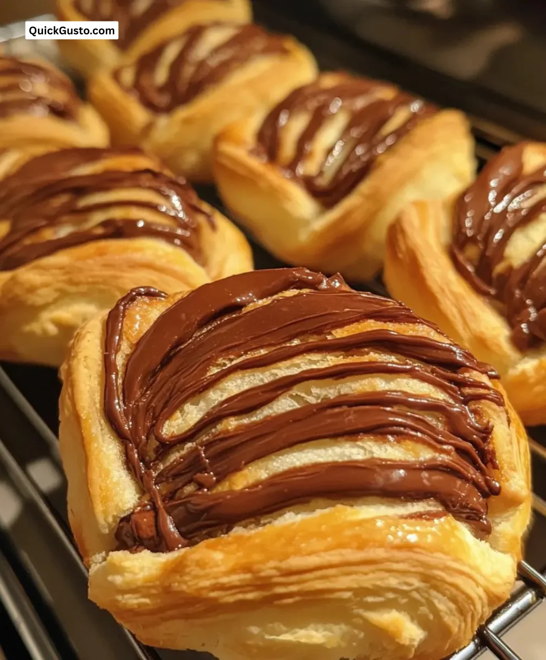 Irresistible Nutella swirl pastries in flaky puff pastry on a plate