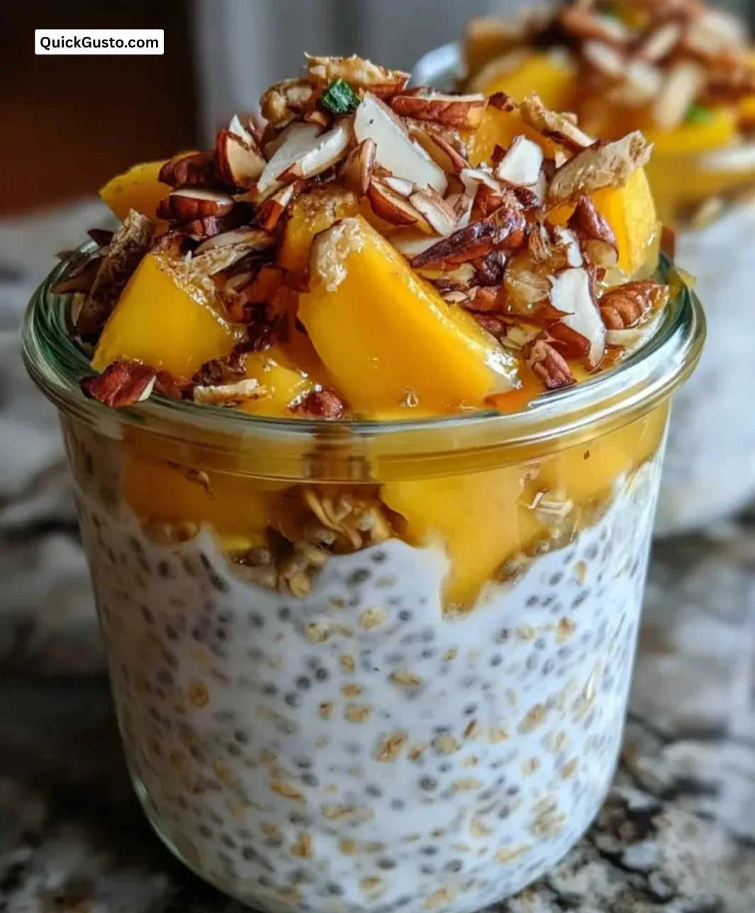 Bowl of Mango Chia Overnight Oats topped with fresh mango slices and chia seeds