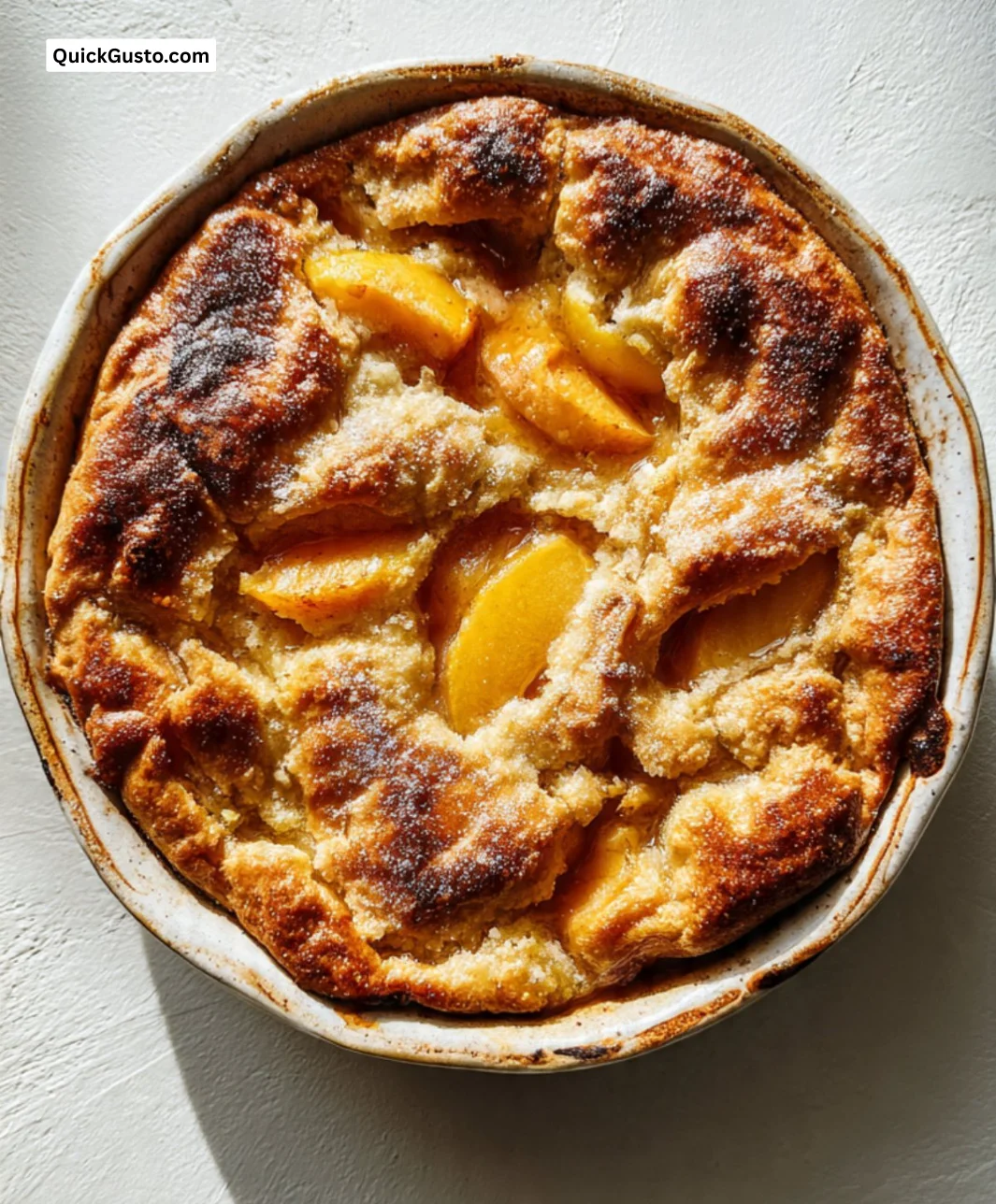 Delicious Old Fashioned Peach Cobbler served with vanilla ice cream