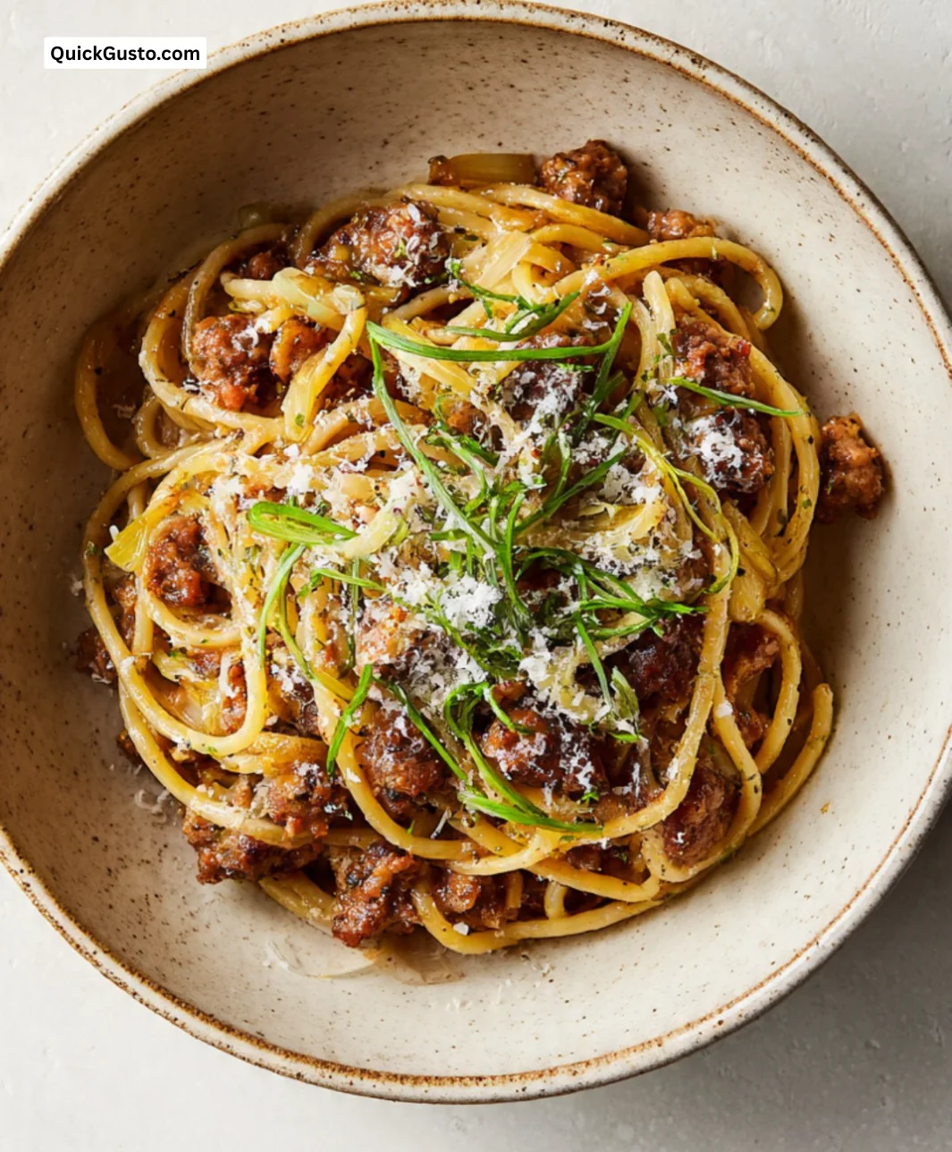 A variety of pasta types including spaghetti, penne, and fusilli on a wooden table.