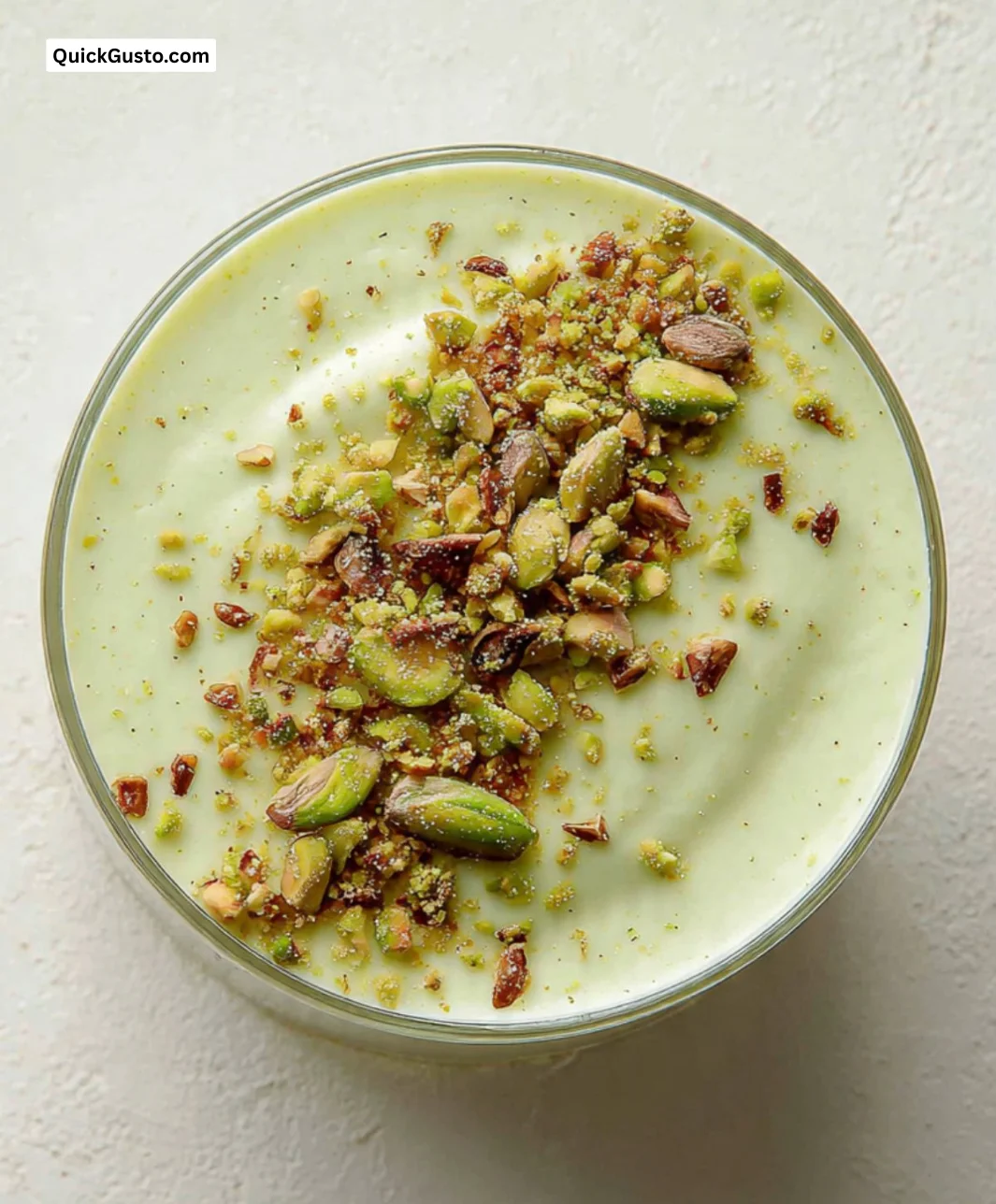 Deliciously creamy pistachio milk pudding served in a bowl with pistachio toppings.