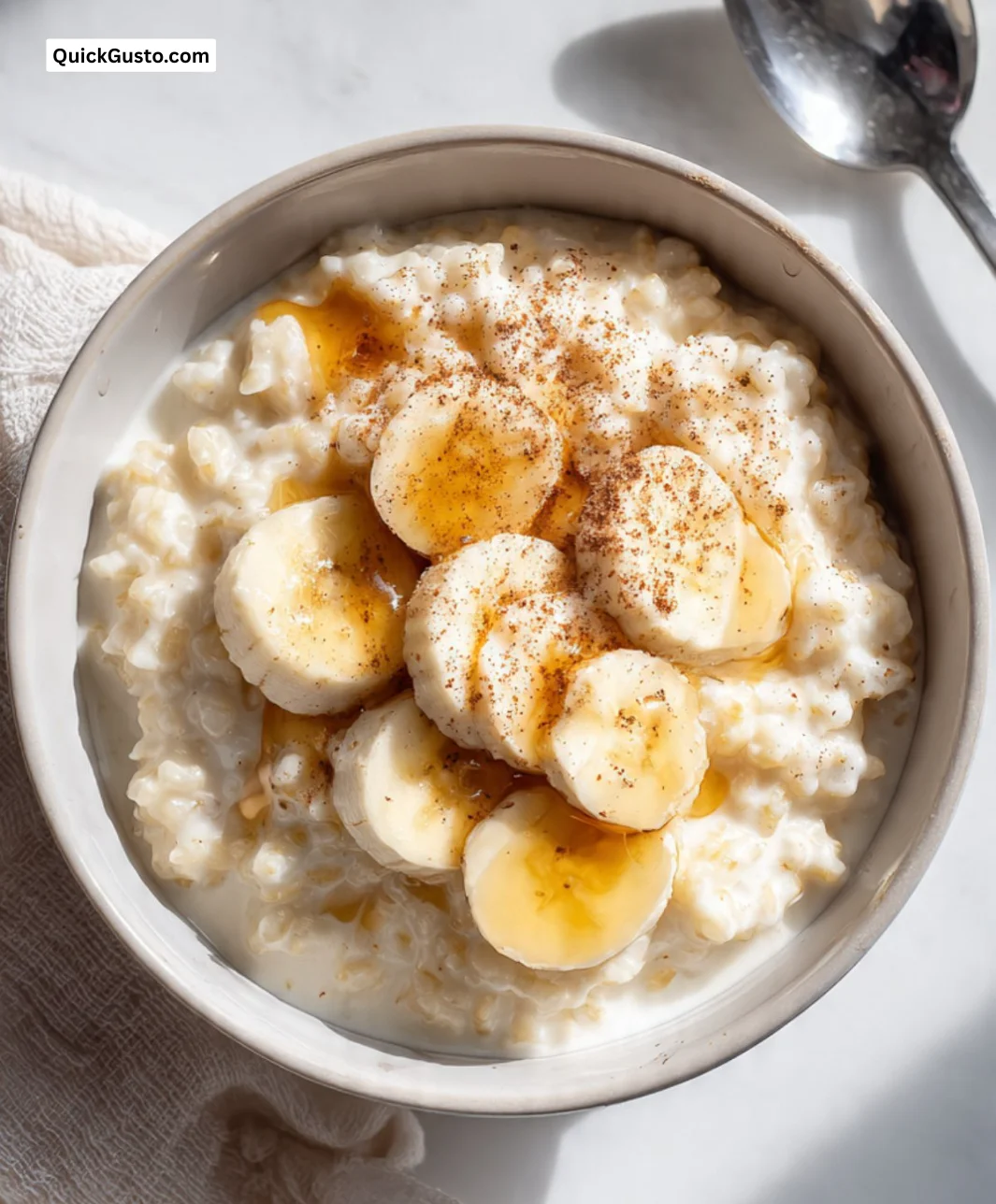 A nutritious rice and milk breakfast bowl topped with fruits and nuts.