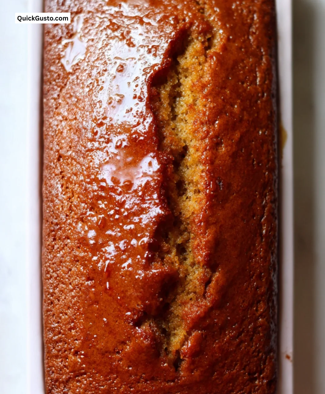 Delicious sticky ginger loaf cake served on a rustic wooden table