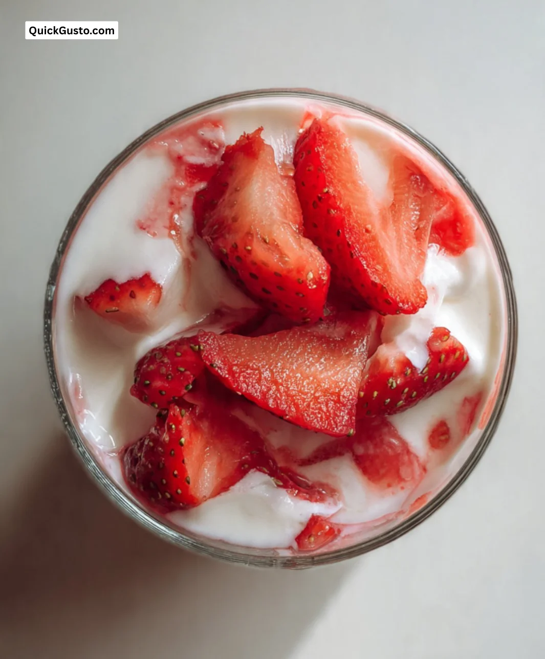 Delicious strawberry yogurt cup topped with fresh strawberries.
