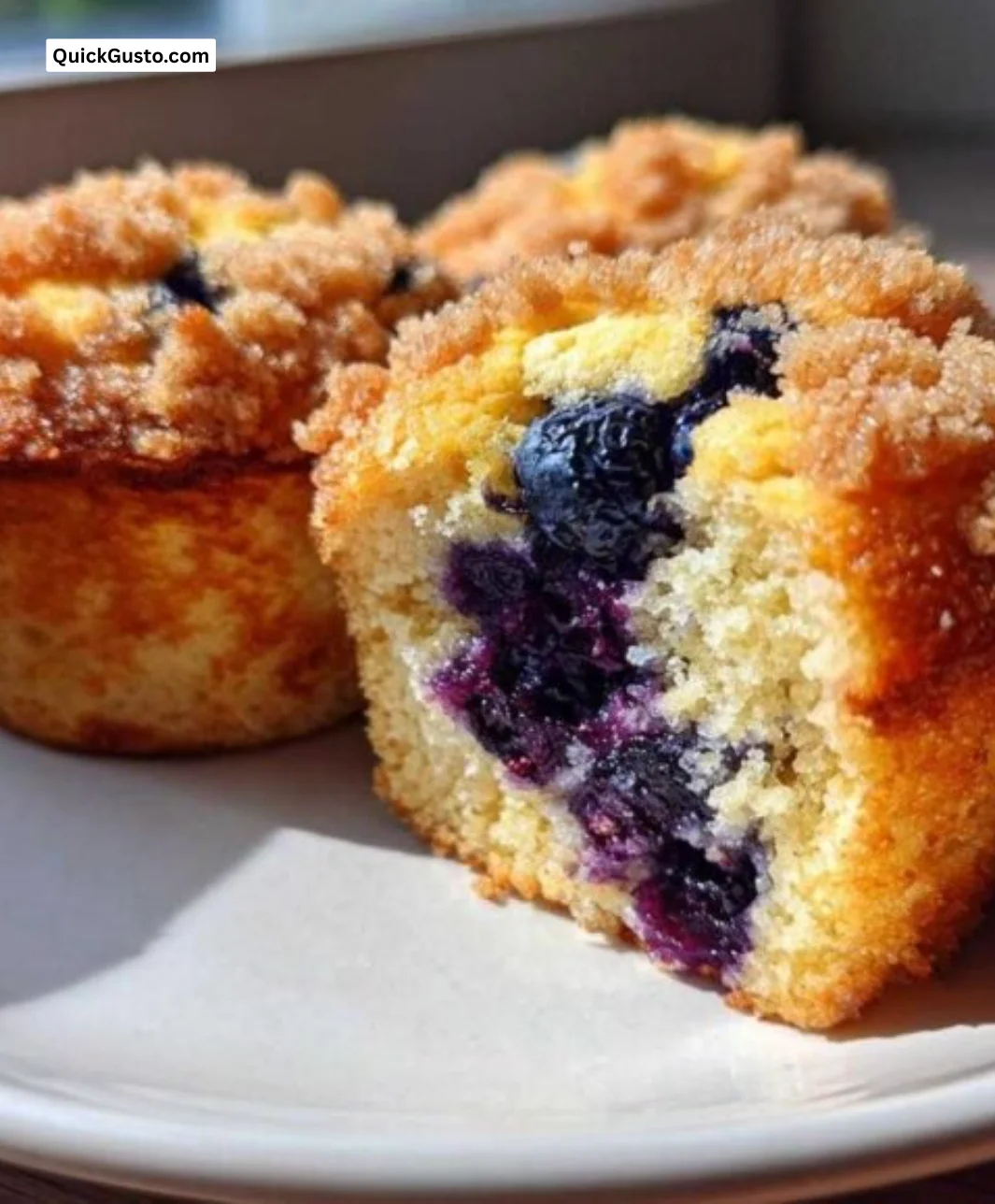 Plate of ultimate moist blueberry muffins fresh out of the oven