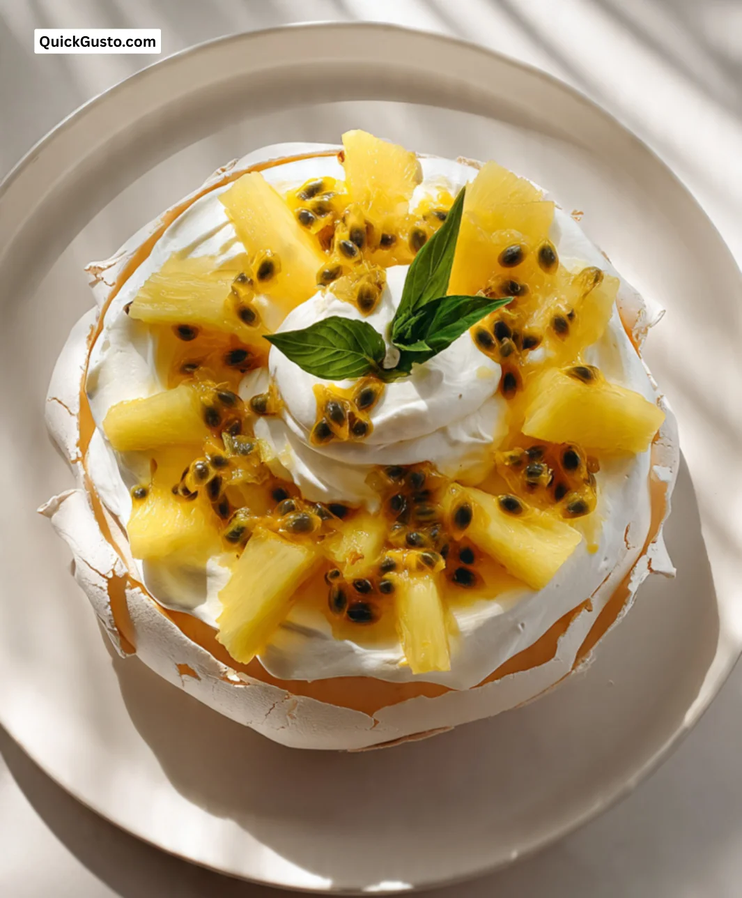 Vanilla Pavlova dessert topped with pineapple and passion fruit