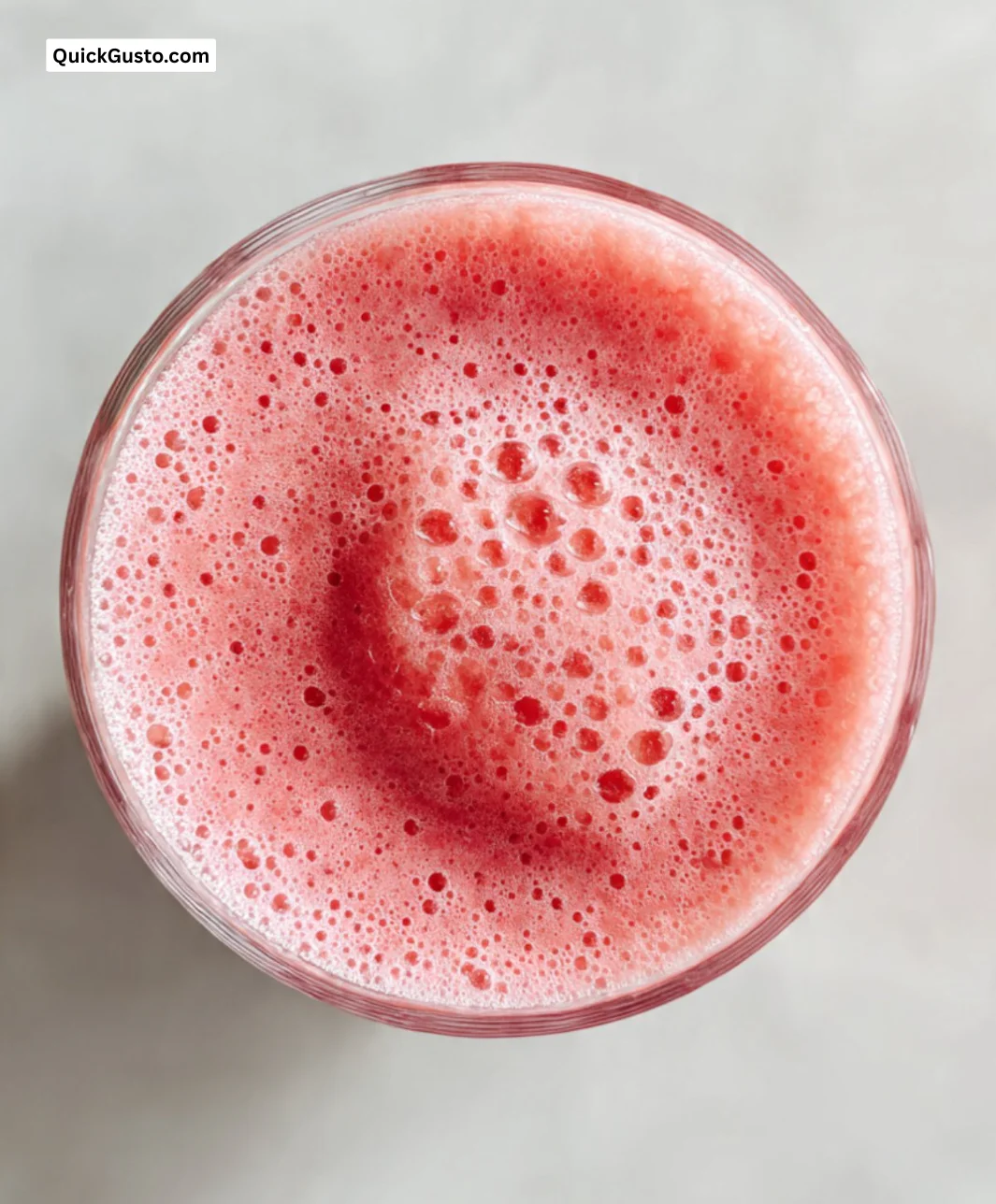 Refreshing watermelon smoothie garnished with mint leaves in a glass