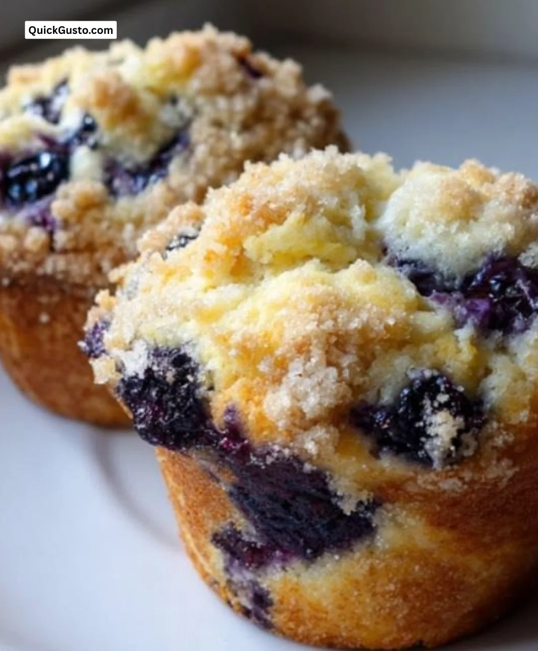 Freshly baked bakery-style blueberry muffins with juicy blueberries