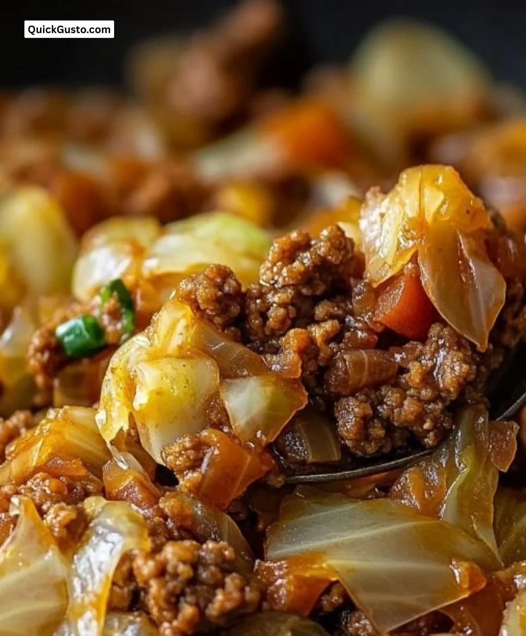 Cabbage and beef skillet dish served on a plate, garnished with herbs.